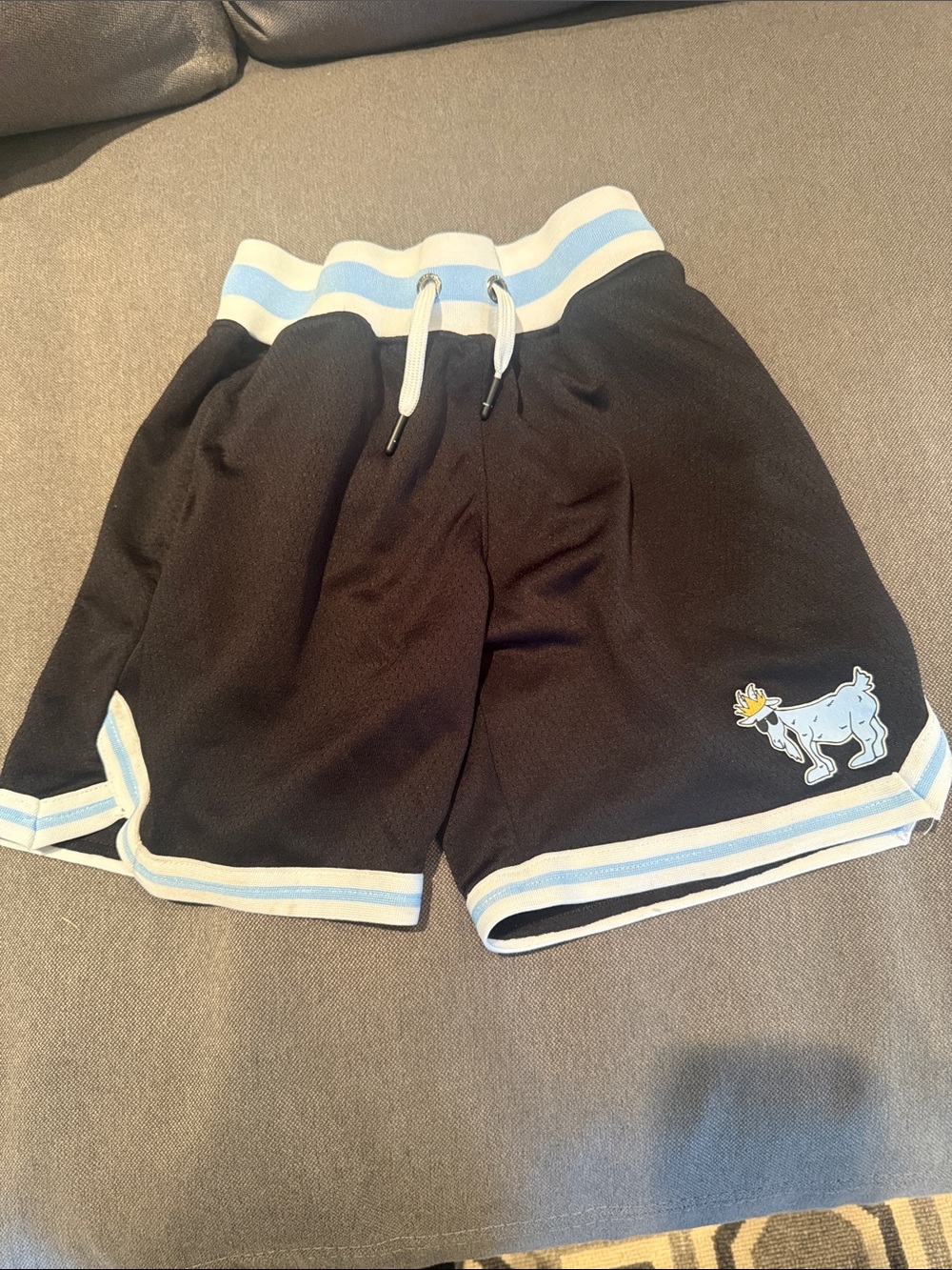 Kids Black Shorts with Light Blue Trim and Playful Patch